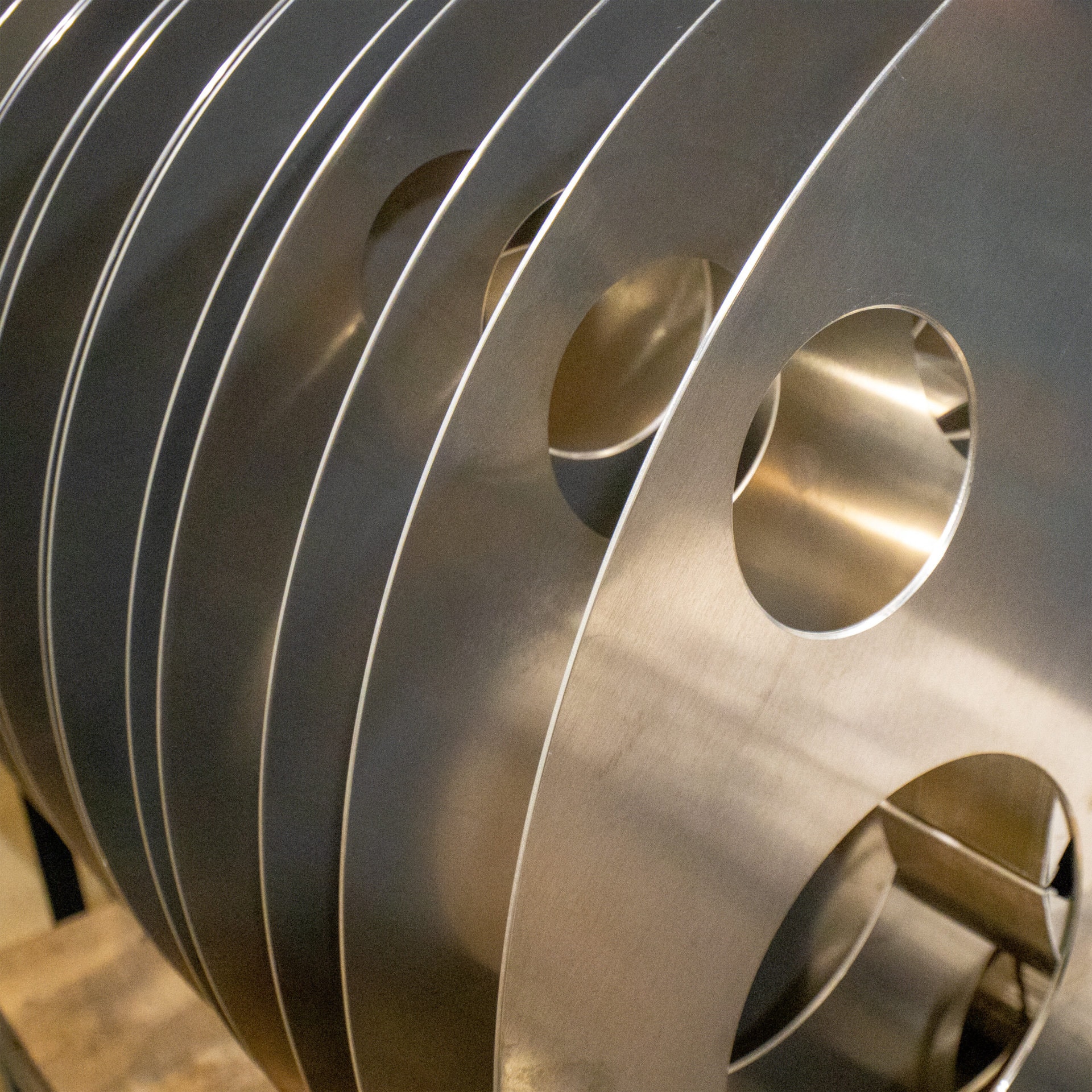 closeup image of several newly-made 70mm aluminum film reels awaiting inspection