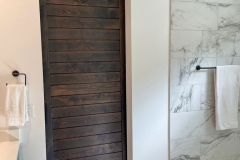 Hidden Roller Hardware on a Custom Made Bathroom Barn Door With Horizontal Slats