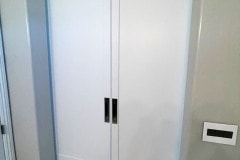 Hidden Roller Hardware on a Custom Made Biparting Pair of White Bathroom Doors