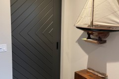 Hidden Roller Hardware on a Custom Made Barn Door With a Geometric Design